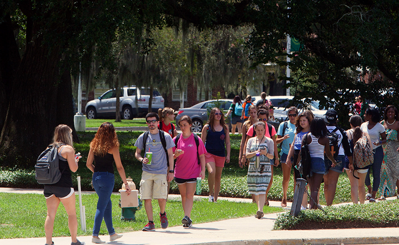 Crowd of Students Walking Across Campus