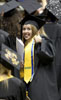 Chelsea Canezaro, a marketing major from Port Allen, gives a thumbs up to her accomplishment of earning her degree.