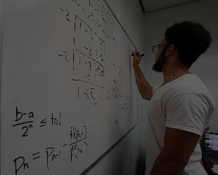 Student Doing Math Problems on Whiteboard