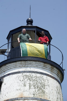Jay Martin and Raj Pandian fly Southeastern flag from Tchefuncte River lighthouse