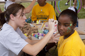 A Family Day participant gets her face painted.