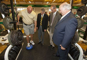  (2)Southeastern Louisiana University strength and conditioning coach Scott Reeves demonstrates a conditioning technique in the newly dedicated Naquin Strength and Conditioning Center. Observing are, from left, Southeastern President John L. Crain, Athletic Director Tim Baldwin and Hammond businessman Ray Naquin.