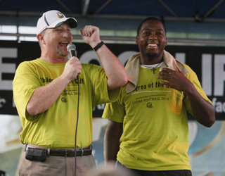 Football Coach Mike Lucas gets the crowd fired up at the pep rally during Lionpawlooza at Hot August Night.