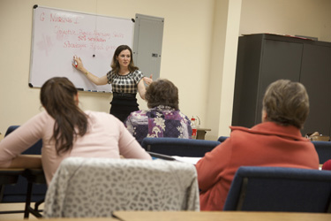 Amber Narro, a professor in the Department of Communication at Southeastern Louisiana University, lectures to Hammond's Compass Career College instructors about the importance of incorporating social networking and technology into course design. 