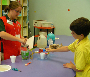 Rebecca Harris works with Ethan Keller on a science experiment at Super Science after Hours.