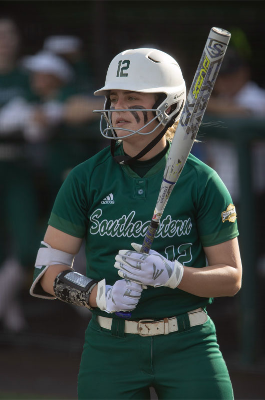 Baseball player holding bat.
