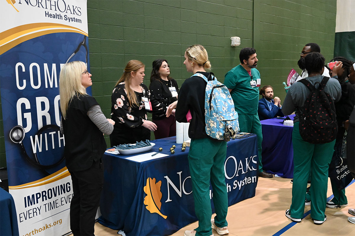 Students speaking with health professionals at Southeastern.