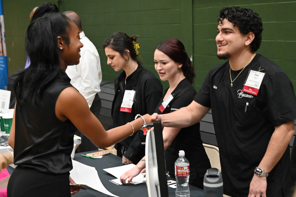 Employer shaking hands with a student at one of our specialized career fairs at Southeastern.