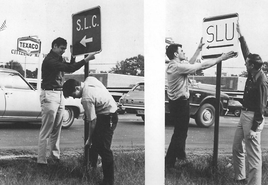 Students switch out signs for Southeastern Louisiana College and Southeastern Louisiana University.