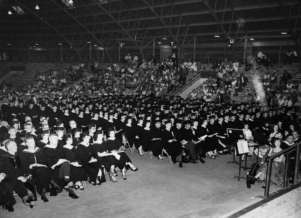 Students sit for a graduation ceremony, circa 1960s