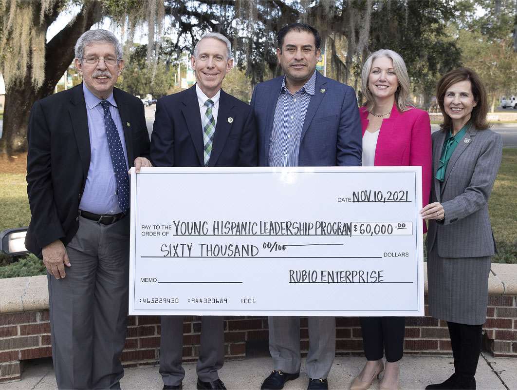Leaders of the Young Hispanic Leadership Program holding a check