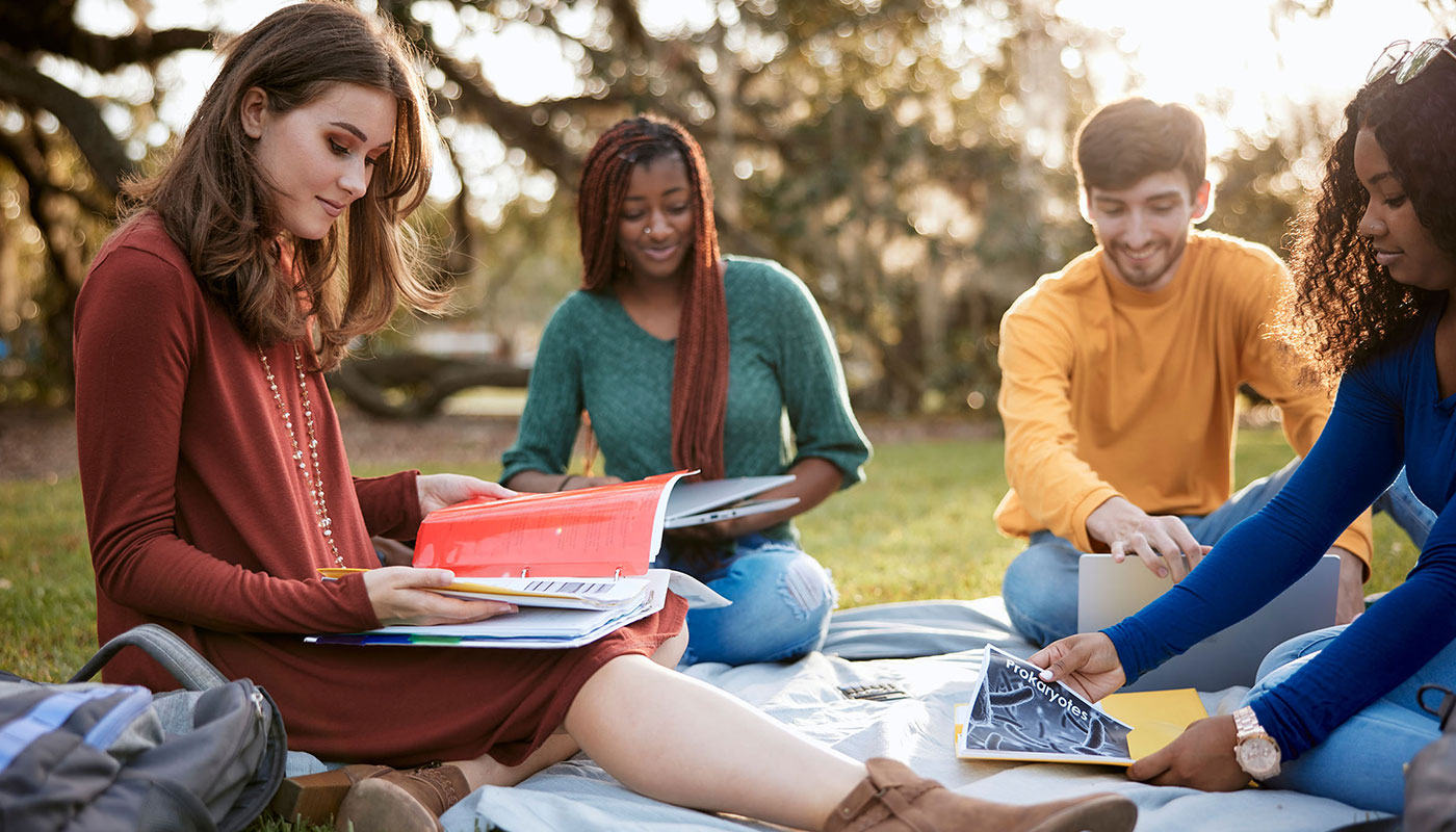 Southeastern students studying on grass
