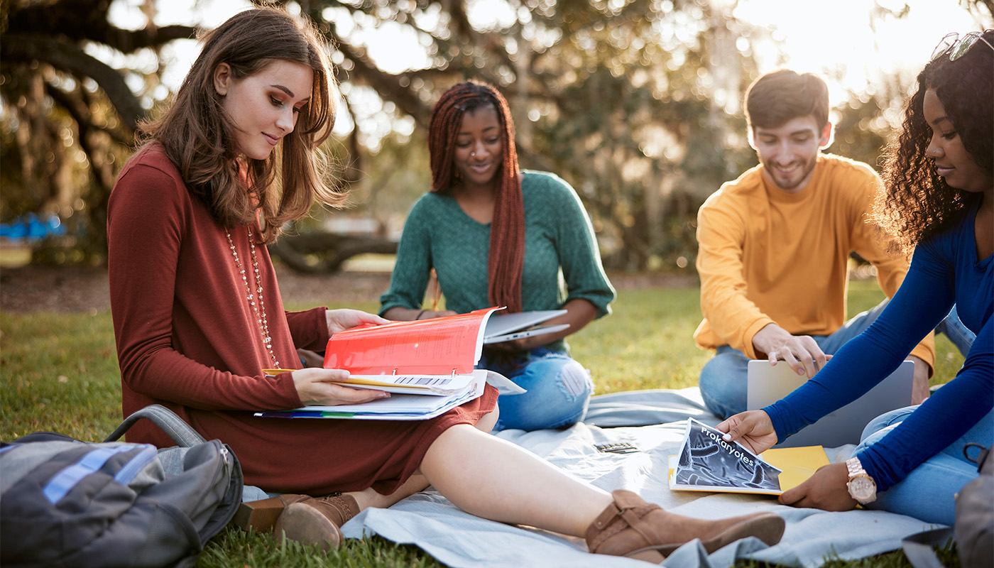 Students sitting around Friendship Oak