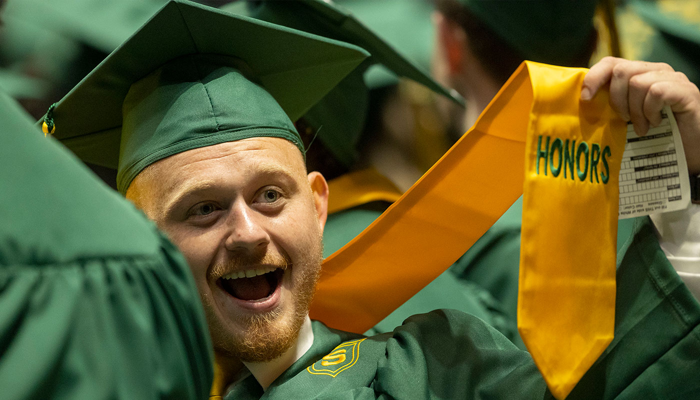 honors student holding up honor's sash