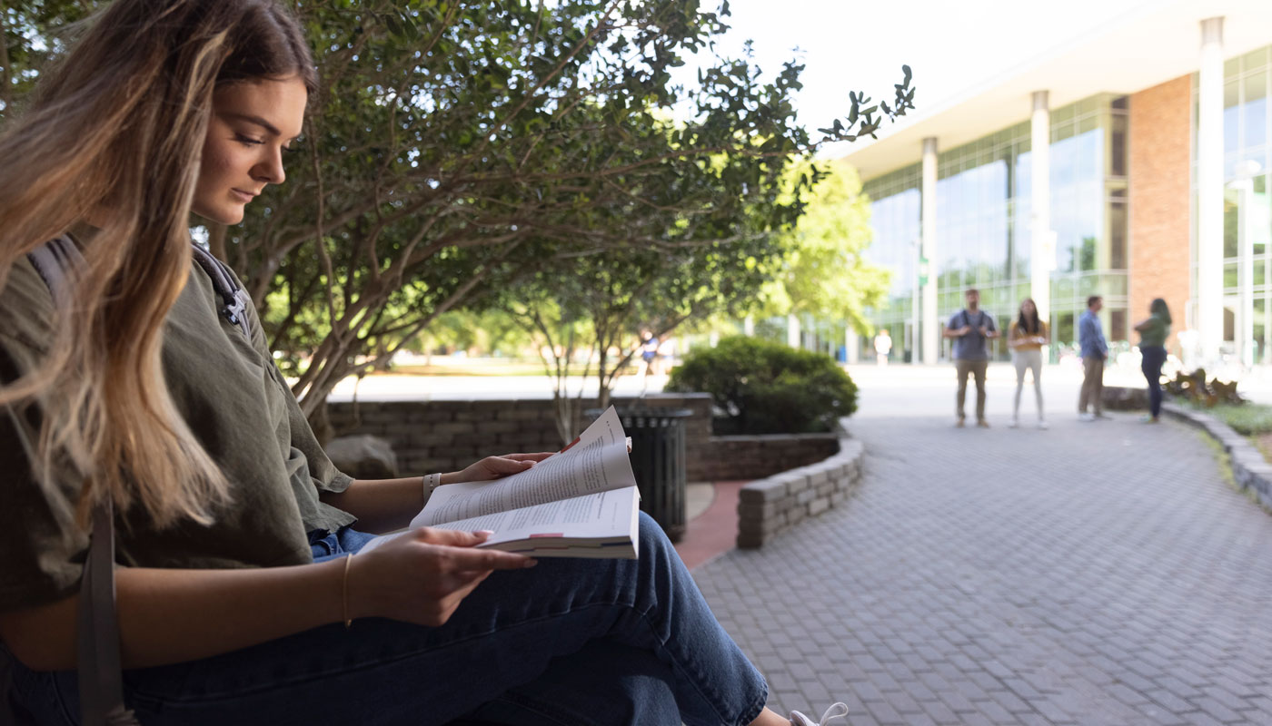 female student reading a book