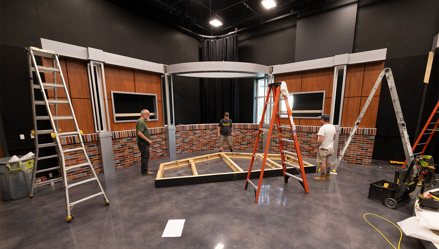 Pictured are crew members putting the finishing touches on one of the three broadcast media studios.