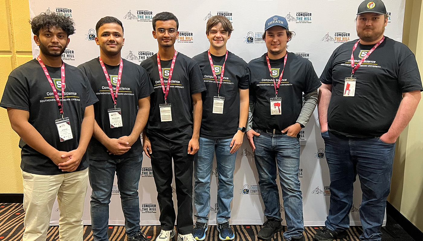 Computer science students pose for a photo after winning a national competition.