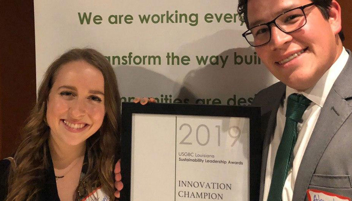 woman and man holding 2019 innovation champion award