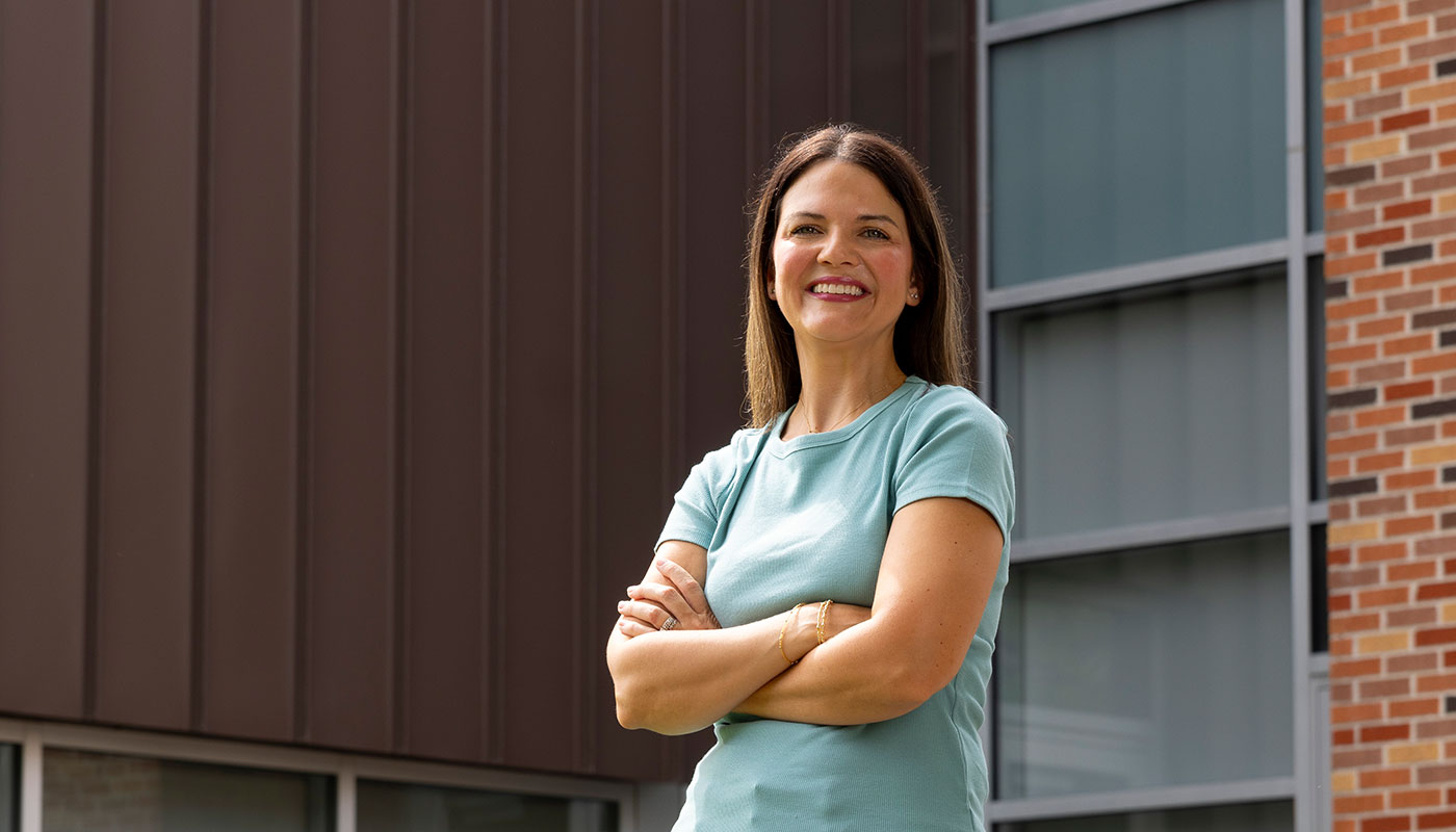 Nursing student Jacy Costa stands in front of the nursing building