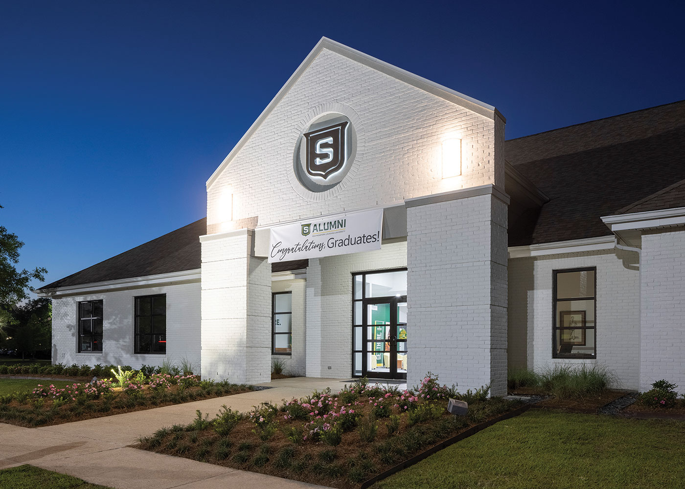 front of the Alumni Visitor Center at night