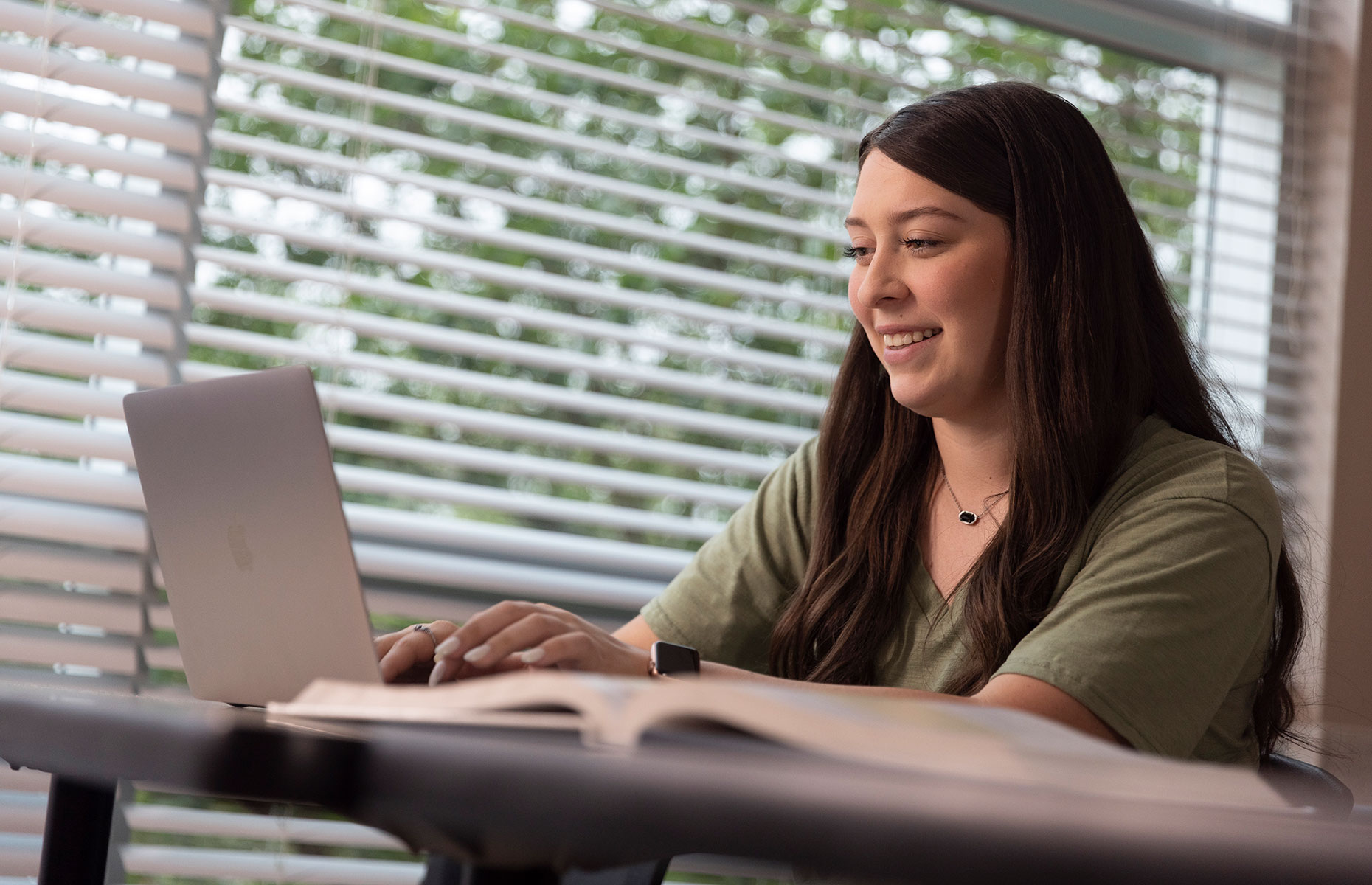 Breanna Dominguez typing on a computer.