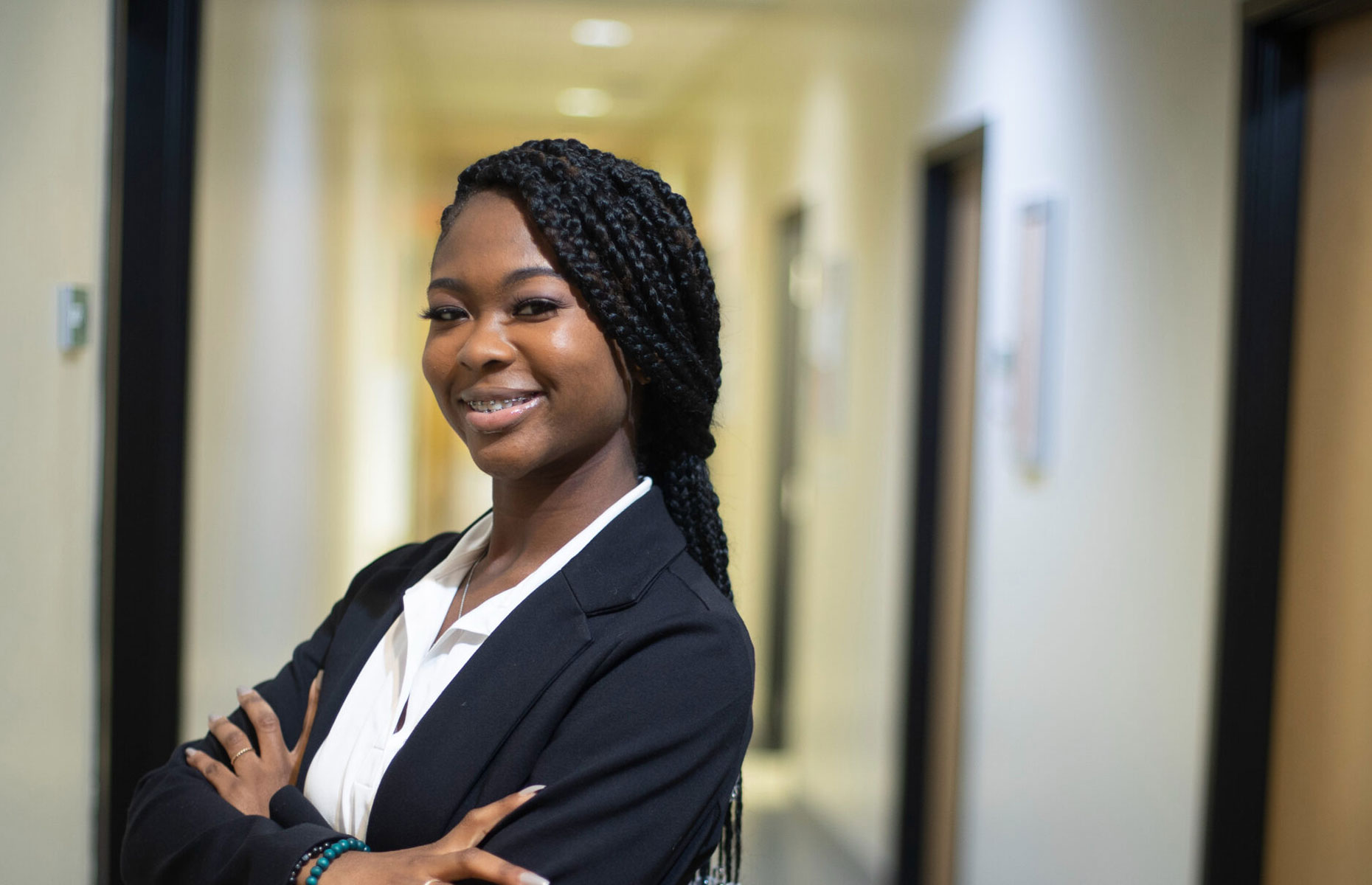Student standing with a suit on.