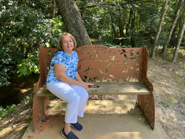 Jeanne Brooks sitting on bench.