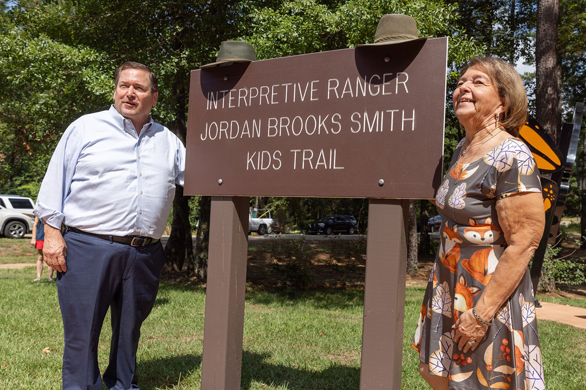 Jeanne Brooks standing in front of Jordan Brooks Smith sign.