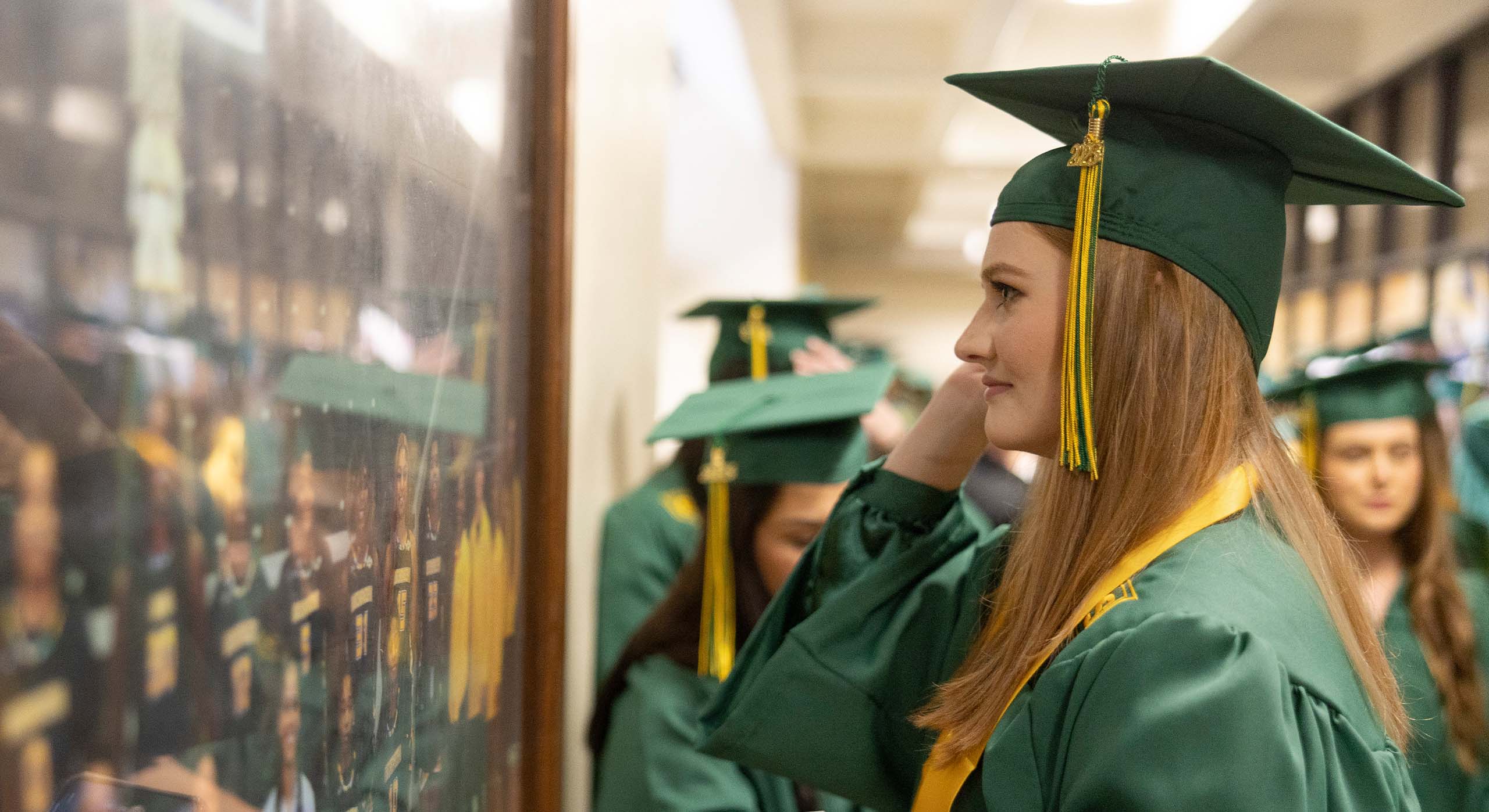 Graduate looking at photos.
