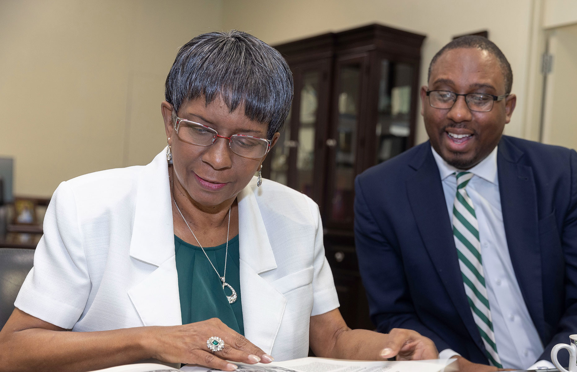 Patricia Campbell and son looking at a yearbook.