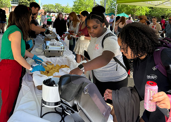 students getting served gumbo at Gumbo YaYa