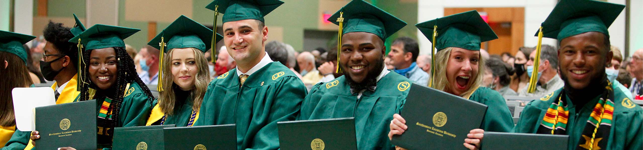 Students smiling at graduation.