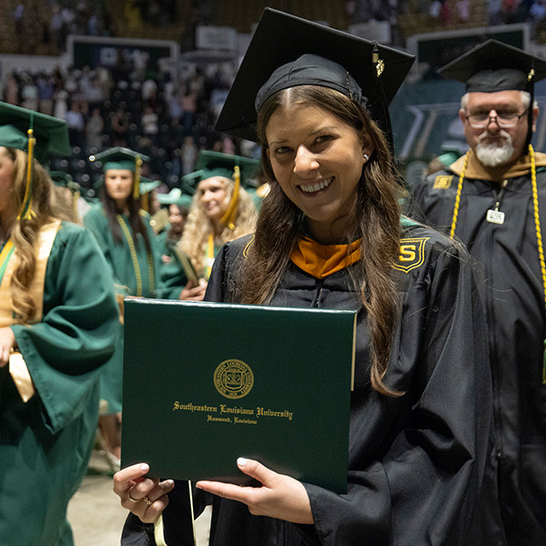 Graduate smiling with her degree.
