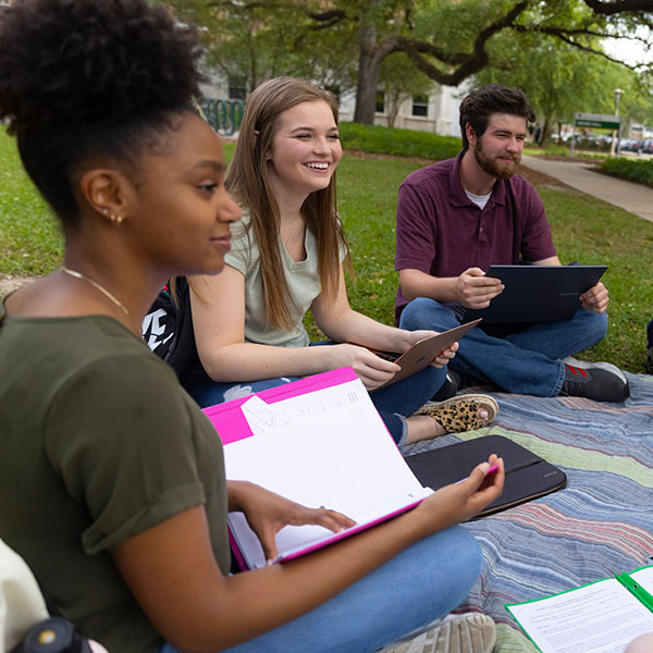 Students sitting outside talking.